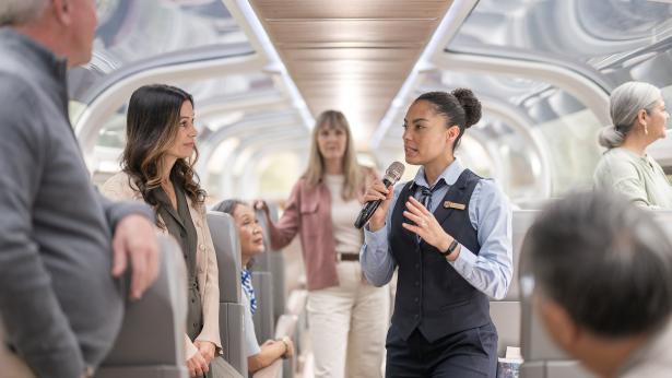 Onboard host speaking with guests